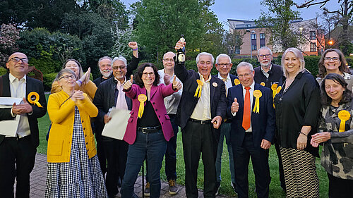Outside Allum Hall at dawn, a group of newly elected councillors and their colleagues celebrate their success in the May 2023 local elctions