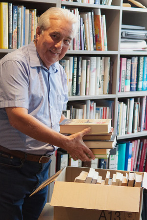 Laurence Brass packs a box of books for the community library